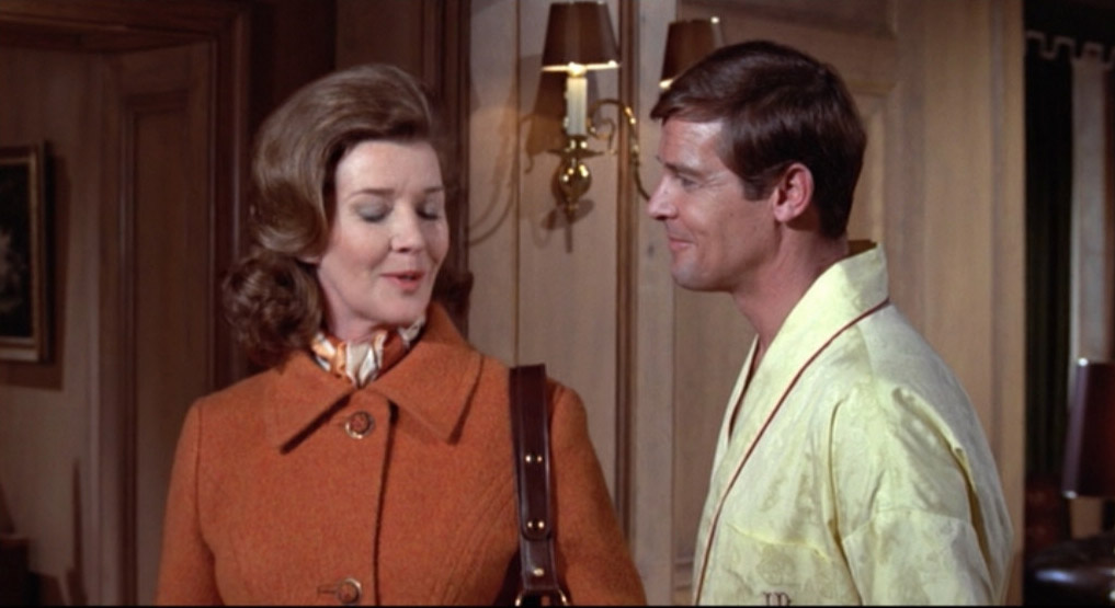 Lois Maxwell as Miss Moneypenny and Roger Moore as James Bond in Live and L...